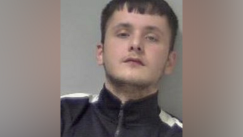 Police mugshot of drug dealer Kai Stretton in black tracksuit top