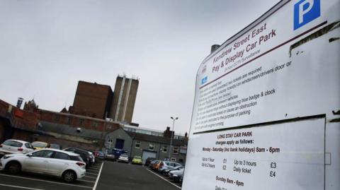 Kendrew Street East car park in Darlington. Several vehicles are parked in bays, while on the right-hand side of the photograph is a pay-and-display sign notifying drivers of the charges.