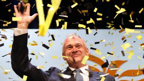Liberal Democrat Leader Ed Davey waves after giving his closing speech to the Autumn Conference