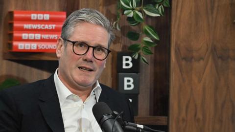 A seated Sir Keir Starmer, the British Prime Minister, speaks during in the BBC Newscast studio during an interview