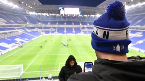 A fan taking a photo of the new Everton stadium