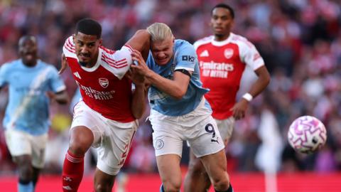 William Saliba of Arsenal battles for possession with Erling Haaland of Manchester City during the Premier League match between Arsenal and Manchester City at Emirates Stadium on September 21, 2025