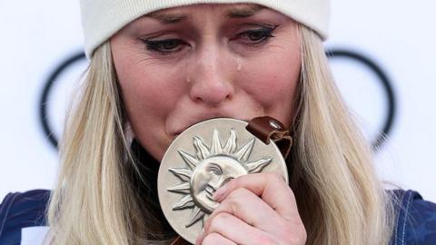 Tears fall from the eyes of Lindsay Vonn as he kisses her medal after a second-place finish in the women's Super-G during the World Cup finals at Sun Valley Resort, Idaho, on 23 March