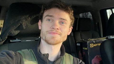 A smiling Chris Parry in a vehicle