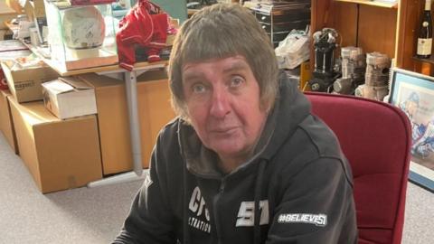 Image of Ted Midgley. He has a mod haircut and is wearing a black jumper. 