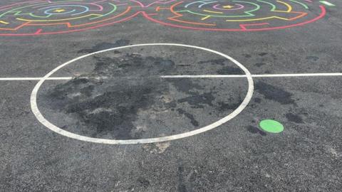 The middle of the Multi Use Games Area has a a large dark patch where the fire was