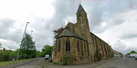A general view of the building on Newport Road in Middlesbrough. It is a large stone church with arched widows and a bell tower and sits on the corner of two roads. There are terraced houses in the distance.