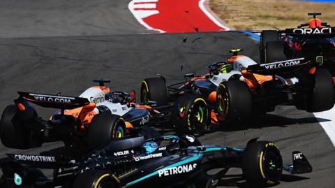 The McLarens of Lando Norris and Oscar Piastri collide at the first corner of the United States Grand Prix sprint race