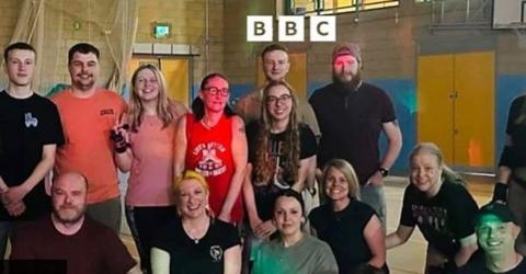A group of people of different ages who are taking part in a roller skate challenge.