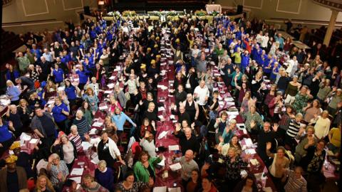 An aerial shot of the Villa Marina, hundreds of people are sitting at long dining tables.