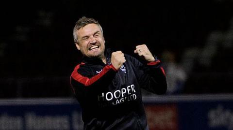 Lincoln boss Michael Skubala celebrates his side's win at Northampton