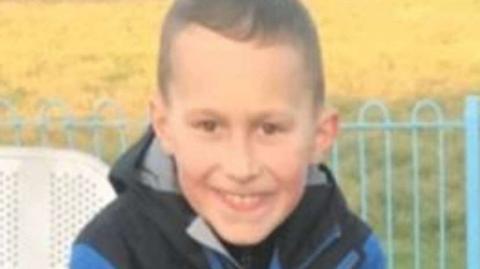 Layton Carr. He is smiling and has short dark hair