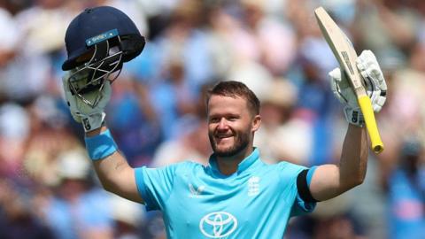 England opener Ben Duckett raises his helmet and bat to celebrate hitting a century