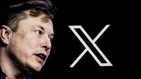 Close up of Elon Musk's face, with big X letter behind him. The letter is white and the background is black.