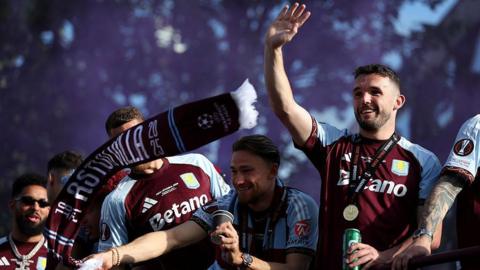 John McGinn of Aston Villa waves to fans during the Aston Villa trophy parade