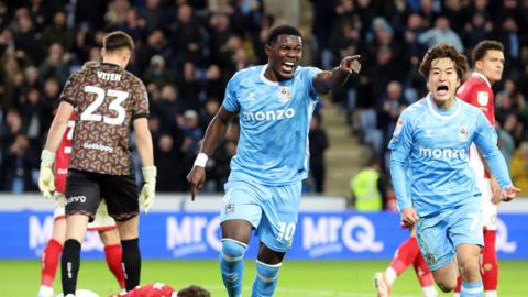 Ephron Mason-Clark (left) runs while pointing his finger with his arm outstretched after scoring