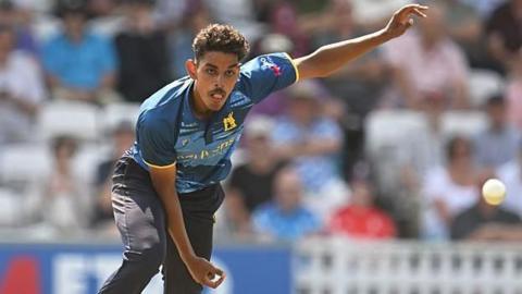 Tazeem Ali is in his follow through after sending down a leg-break in a One-Day Cup game for Warwickshire