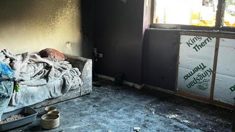 Tia Henderson's smoke-damaged living room, following the blaze on 12 August. 