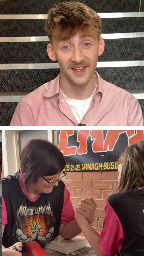 A split image shows a man talking into the camera. He is wearing a pink shirt and a white tshirt. He has short fair hair and moustache. Below are two women arm wrestling.