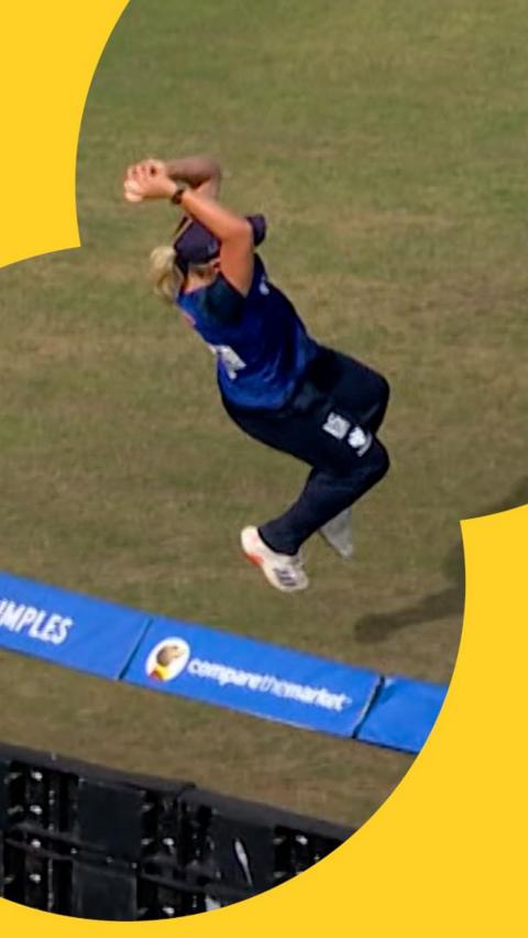 Katie George leaps to prevent a six at the boundary