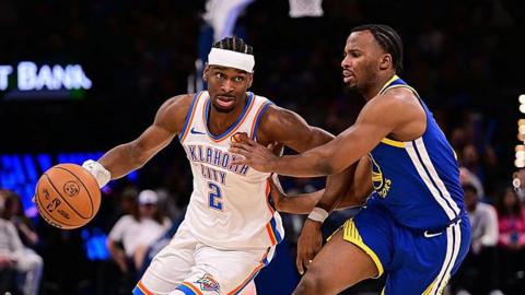 Shai Gilgeous-Alexander of the Oklahoma City Thunder attempts to drive past Lj Cryer of the Golden State Warriors