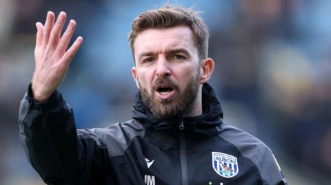 West Brom interim boss James Morrison raises his hands while on the touchline during the 2-1 defeat at Oxford