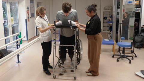 Hamish Wilson walking for the first time on his new prosthetic legs. 