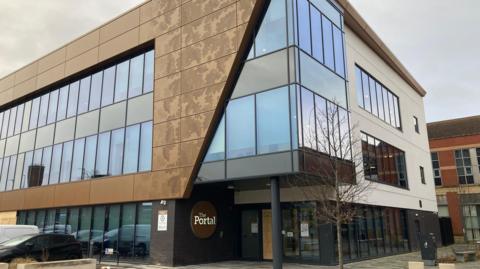 Outside shot of the Portal building in Chester, which houses some council services. It's a modern building with striking gold-coloured features on the outside.