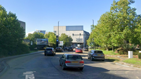 Google maps street view of Newfoundland Way. There are cars driving in multiple lanes and Cabot Circus shopping centre can be seen in the distance.