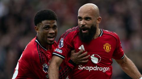 Amad Diallo and Bryan Mbeumo celebrate a goal for Manchester United