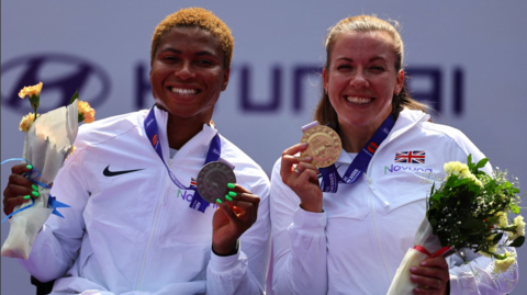 Women's 400m T34 gold medallist Britain's Hannah Cockroft celebrates on the podium along with silver medallist Britain's Kare Adenegan