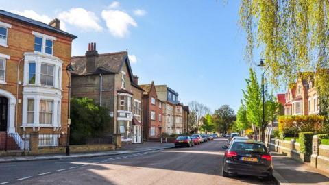 Stock photo of a sunny street lined with houses in West Ealing, London