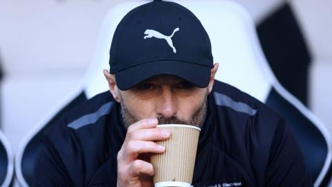 Derby County manager Paul Warne sips from a cup