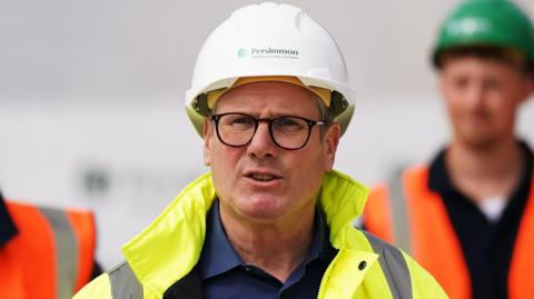 Prime Minister Sir Keir Starmer wears a high visibility jackets and hard hat