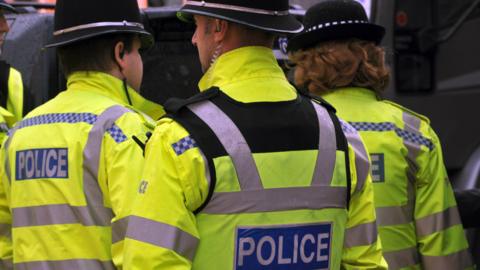 The rear of three West Midlands Police officers