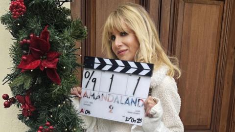 Lucy Punch holds a clapper board.