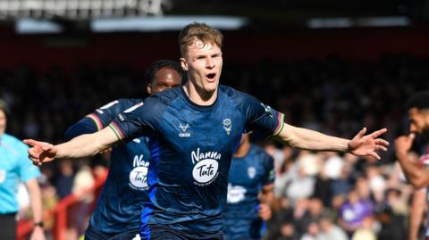 Rob Street celebrates scoring an equaliser for Lincoln City against Stevenage