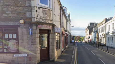 A google view of Main Street line on both sides with shops at its junction with Bank Street.