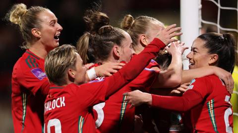 Wales women celebrate a goal