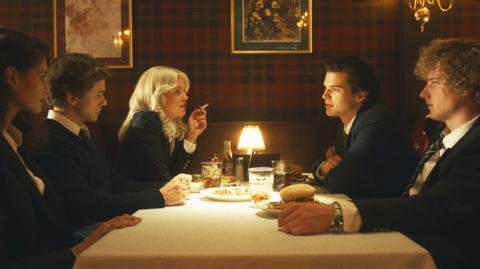 A group of young people sitting around a table