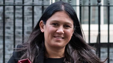 Lisa Nandy smiling in front of railings