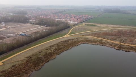 An aerial shot of the new houses near the lake and park