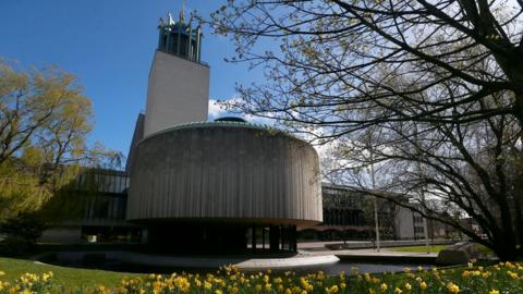 Round building with tower on sunny day