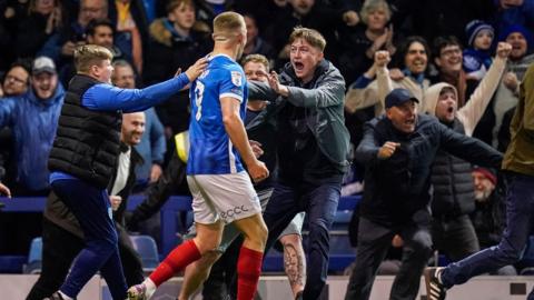 Fans invade the pitch at Portsmouth