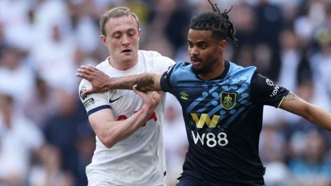 Burnley's Lorenz Assignon holds off Tottenham's Oliver Skipp