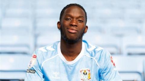Romain Esse poses in his Coventry City shirt