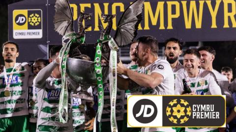 The New Saints players celebrate by holding up the Cymru Premier trophy