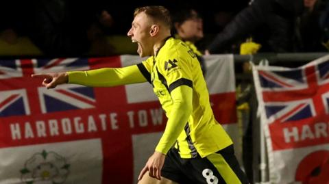 Dean Cornelius of Harrogate Town celebrates scoring against Gainsborough Trinity