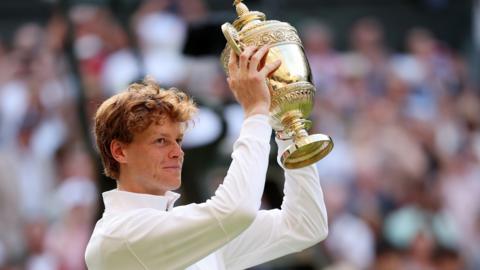 Jannik Sinner with the Wimbledon trophy