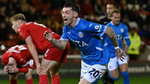 Louie Barry runs to the Stockport fans after his equaliser against Barnsley